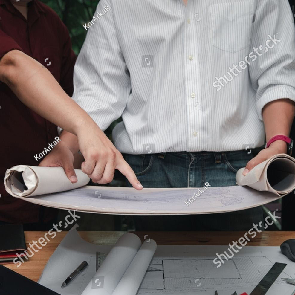 Stock Photo Close Up Of Two Architects Discussing A Blueprint On A Desk Concept Of Teamwork Architecture 2692973625